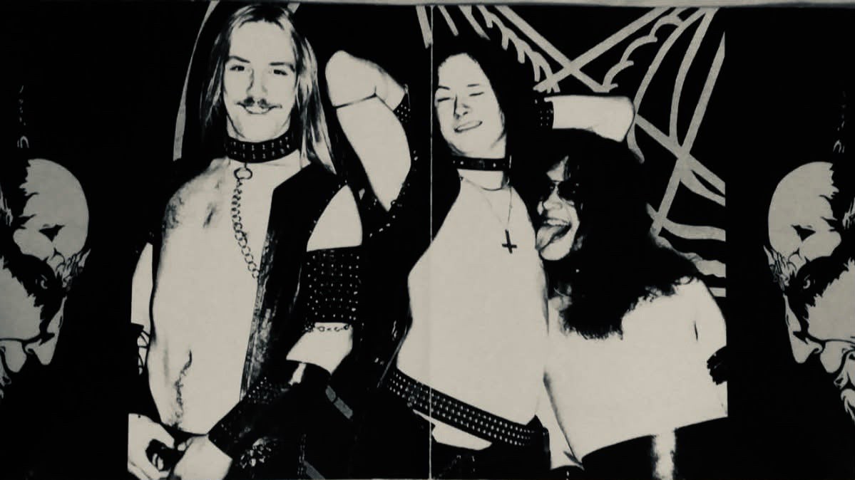 Band portrait, flanked by symmetric skull artwork